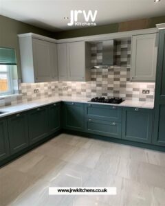 Elegant two-tone bespoke kitchen with contrasting cabinet colours, custom storage, and luxury interior finishes.